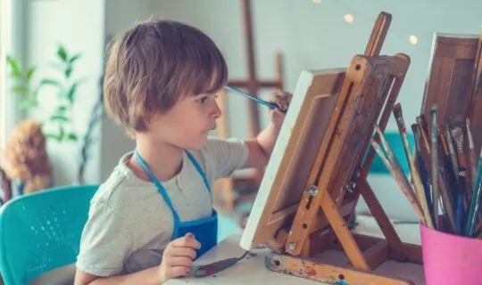 Child painting on canvas