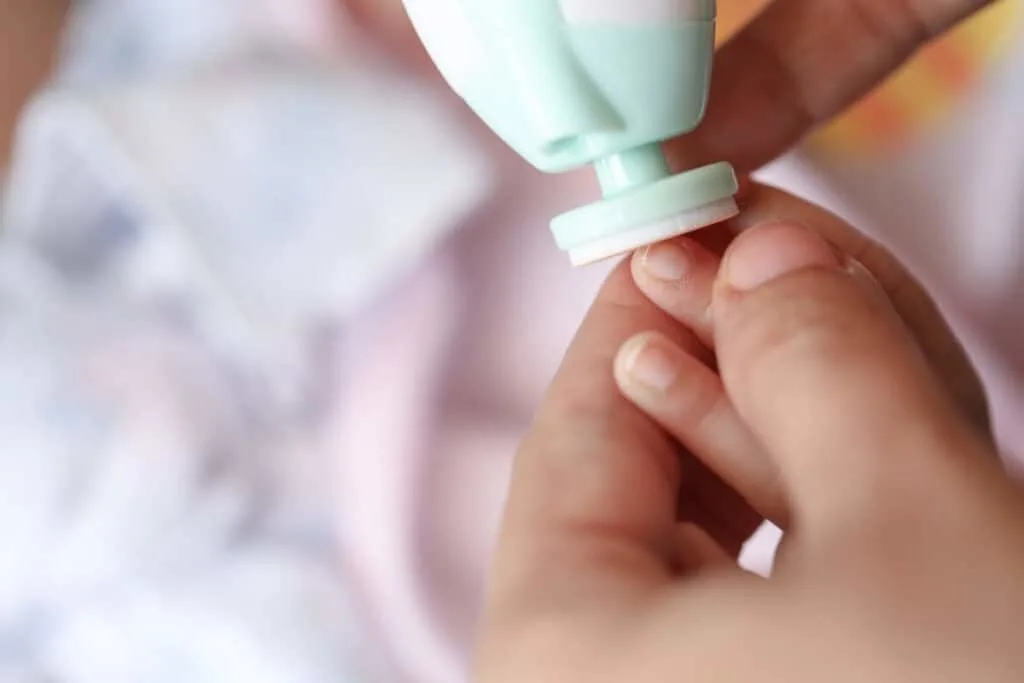 Trimming baby nails with electric nail file