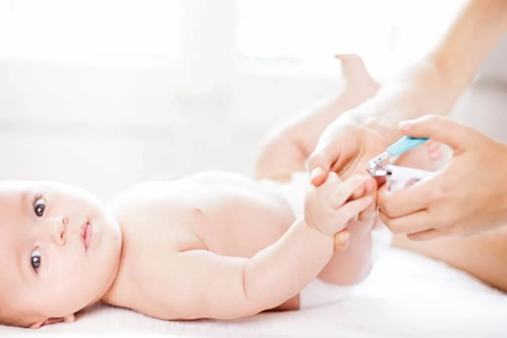 cutting baby nails with nail clipper