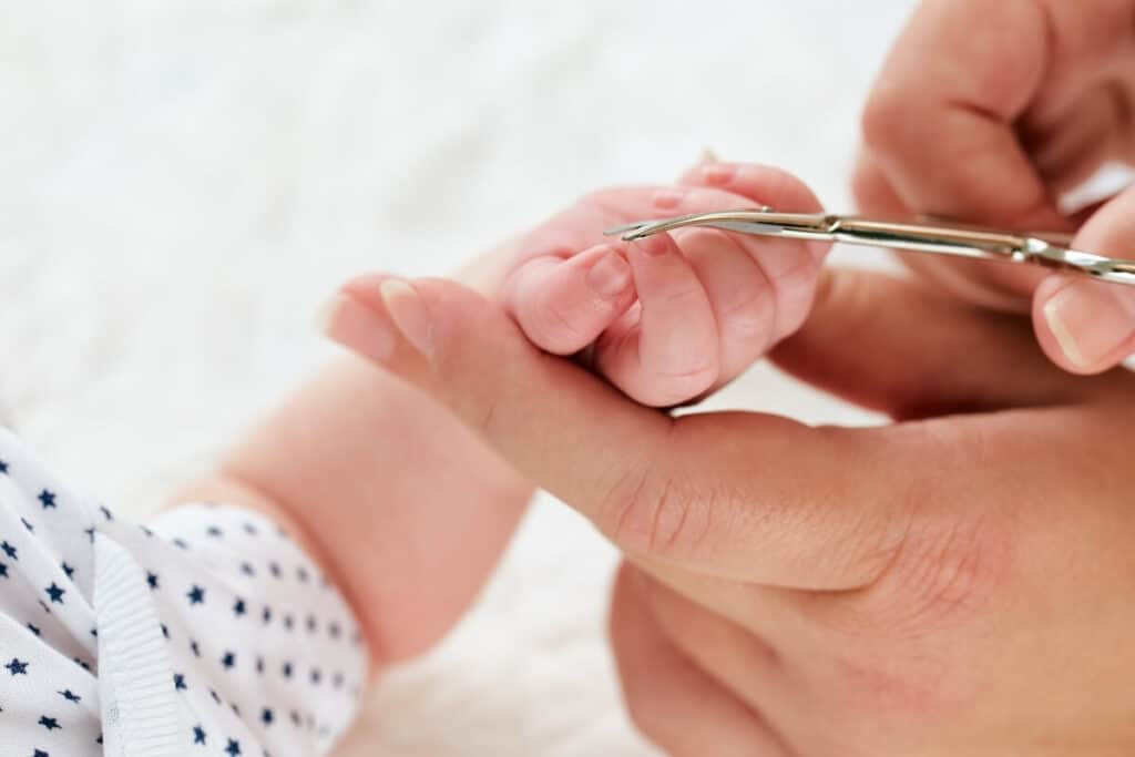 Cutting baby nails with scissors