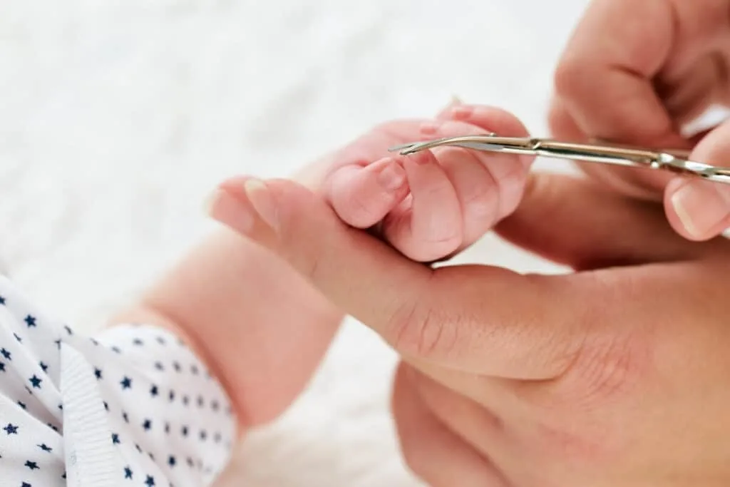 Cutting baby nails with scissors