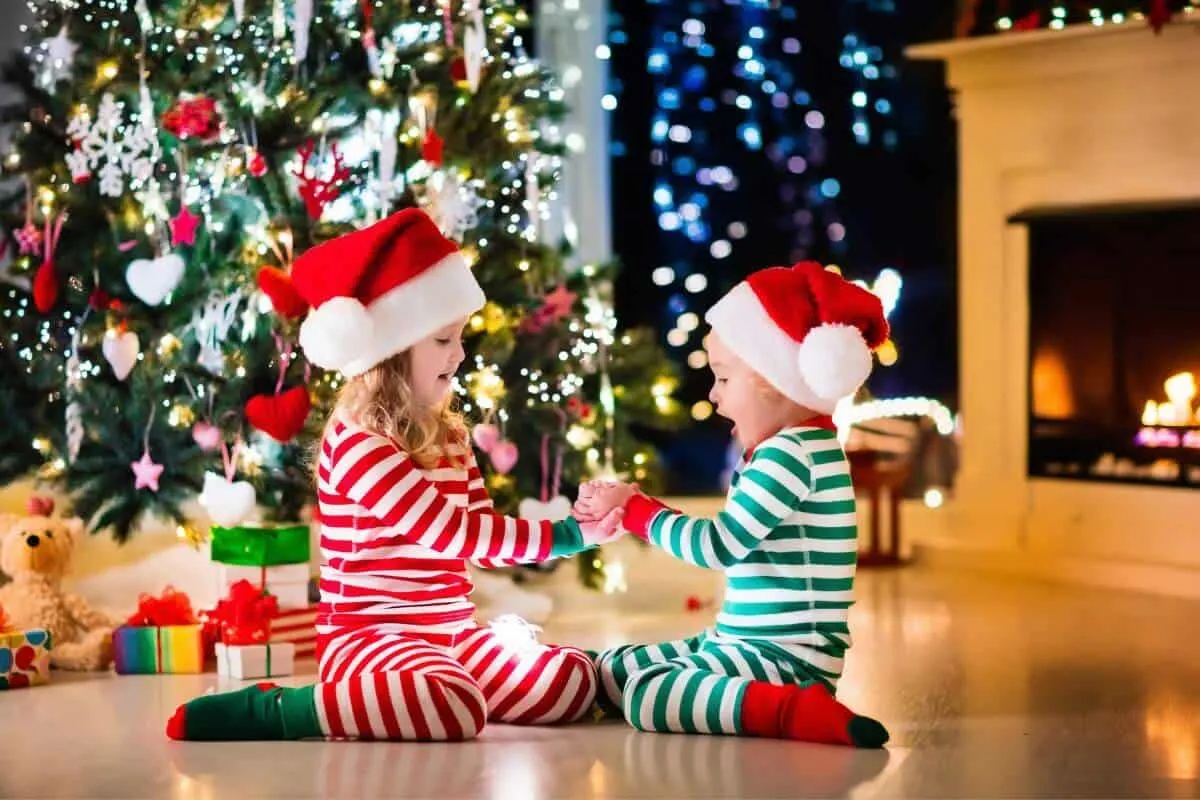 toddlers infront of christmas tree